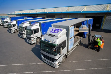 Logistics trucks parked at warehouse facility, showcasing HS Agency's efficient transportation and warehousing solutions for seamless supply chain management in the UK and Ireland.