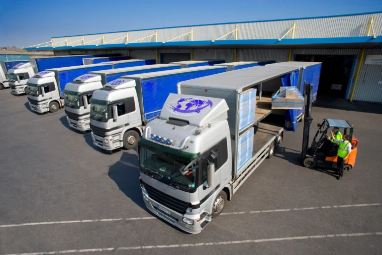 Logistics trucks parked at HS Agency's facility, showcasing efficient transportation and warehousing solutions for seamless supply chain management in the UK and Ireland.