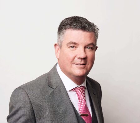 Phil Scullion from CMPC Europe, giving a testimonial about HS Agency, a leader in logistics solutions with over 50 years of experience. The image reflects the company's commitment to trust, integrity, and personalized service in UK and Ireland port agency, transportation, and warehousing logistics.